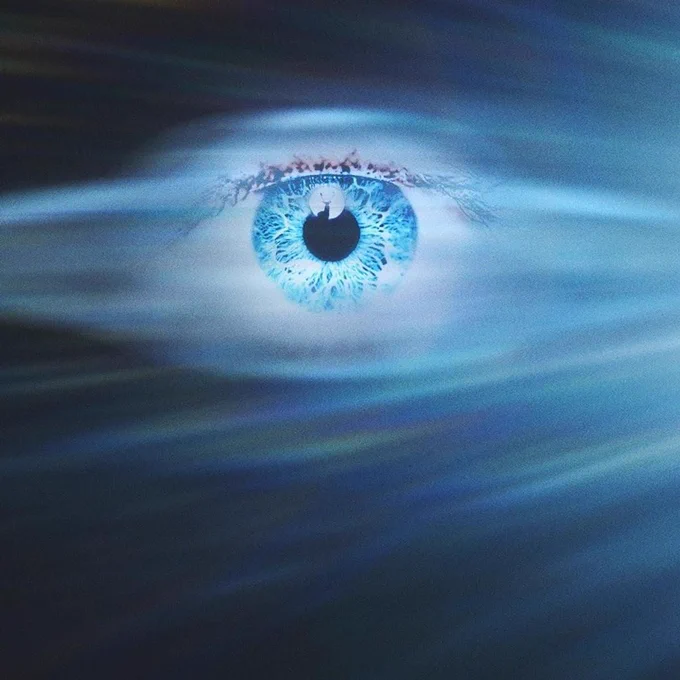 Promo image for the movie Disclosure Day of a blue eye in the sky with bright blue hazy lines fanning out from the right.