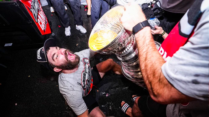 Photo of Jordan Martinook drinking out of the Stanley Cup