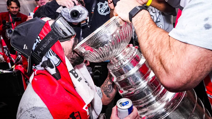 Photo of Seth Jarvis drinking out of the Stanley Cup 