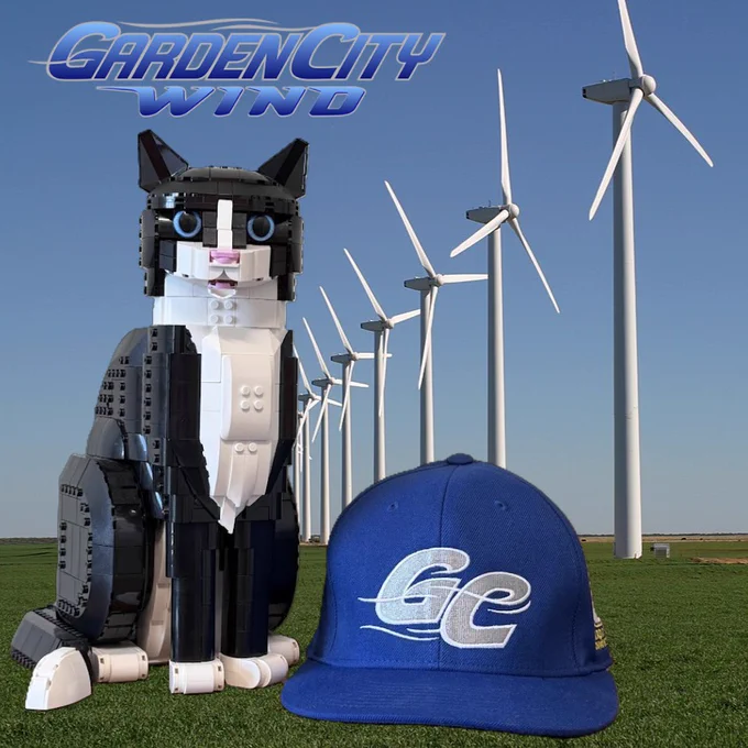 A blue Garden City Wind baseball cap next to HATS the Lego Cat.  A Garden City Wind logo in the upper lefthand portion of the image.  Several wind turbines in the background.