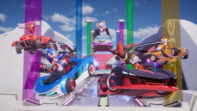 Sonic, Shadow, Knuckles, Tails, and Rouge are mid-jump in their racing machines in Sonic Racing: CrossWorlds.