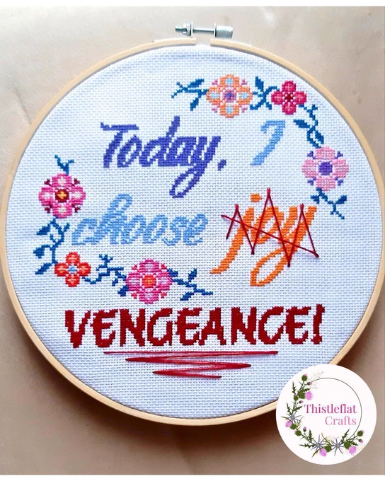 Completed cross stitch in 9 inch hoop saying 'Today I choose joy (with joy scribbled out)...vengeance' Come in a flower and vine border and is in blues, pinks and oranges