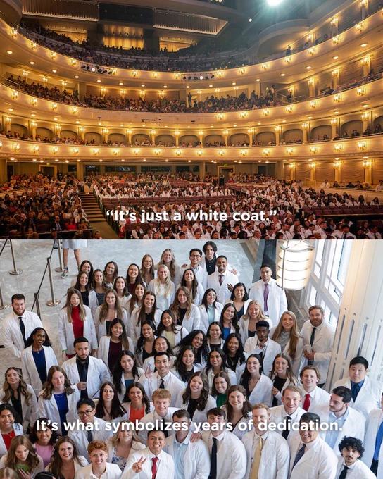 An elegant theater filled with people in the upper section. Below, a large group of individuals in white coats are standing together, smiling at the camera in a well-lit indoor space. Text in the image reads: “It's just a white coat. It's what symbolizes years of dedication.”