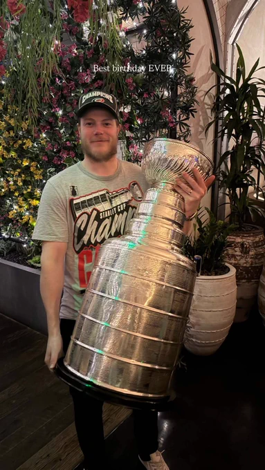 Eric Robinson in Hurricanes championship gear holding the Stanley Cup.