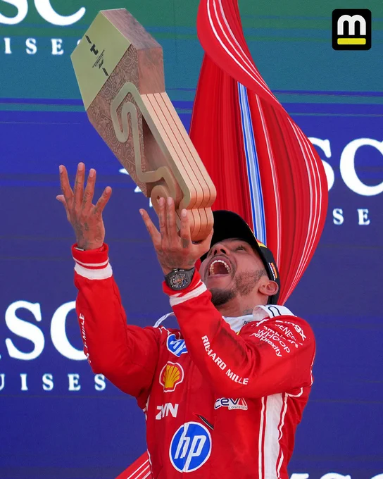 A pixel stretch of Lewis Hamilton tossing his trophy in the air after winning the Barcelona-Catalunya Grand Prix. 