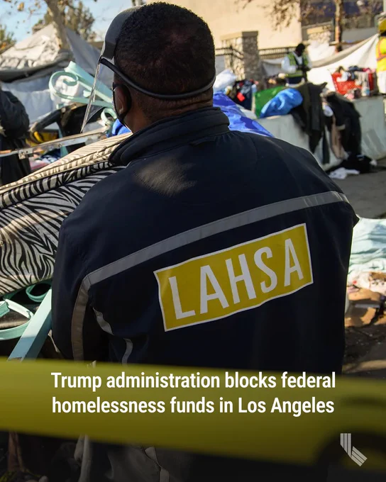 A worker with the Los Angeles Homeless Services Authority (LAHSA) helps a person experiencing homelessness move a cart with their possessions in Los Angeles on on Jan. 28, 2021. Photo by Patrick T. Fallon, AFP via Getty Images