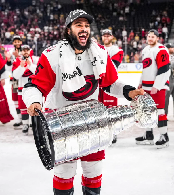 Photo of Jalen Chatfield hoisting the Cup 