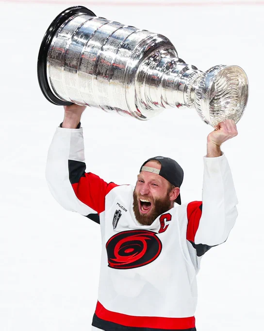 Photo of Jordan Staal lifting the Stanley Cup in a Carolina Hurricanes uniform in 2026.