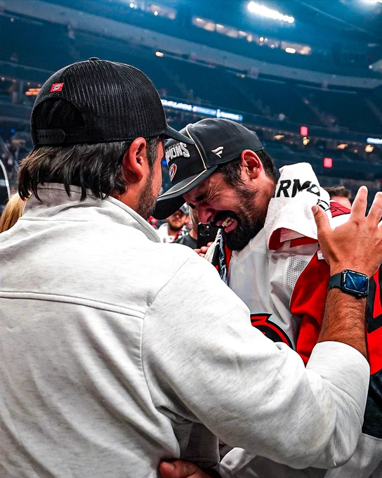 Seth Jarvis embraces his family during Stanley Cup celebrations.