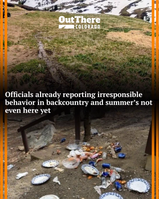 Trash and litter scattered on the ground under a wooden shelter in a mountainous area with patches of snow nearby.