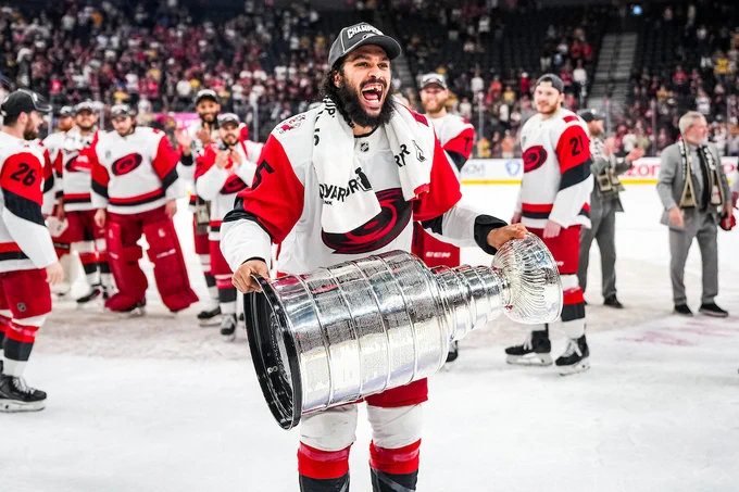 Jalen Chatfield on the ice with the Stanley Cup.