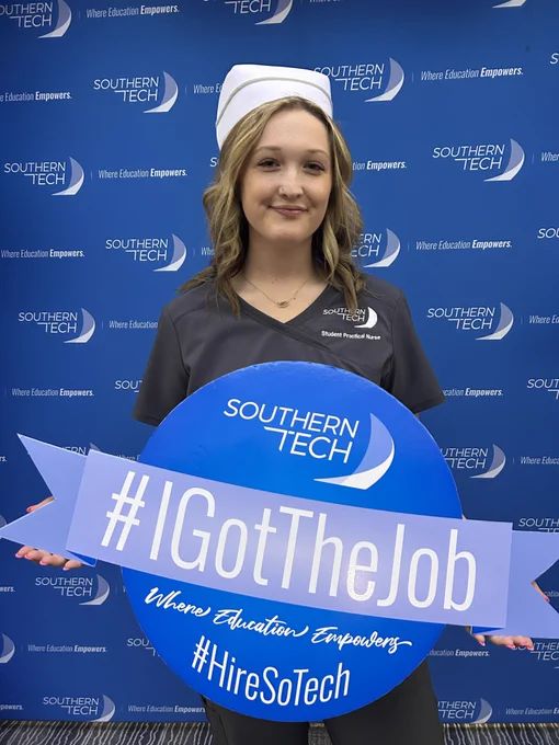 student holding an I got the job sign