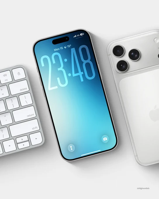 Minimal iPhone lock screen mockup displayed at an angle on a light gray desk beside a white keyboard and a silver iPhone. The wallpaper features a smooth blue gradient that fades from deep navy at the top to soft cyan at the bottom, with large translucent clock digits creating a clean, modern look. The composition emphasizes simplicity, calm tones, and a premium Apple-inspired aesthetic.