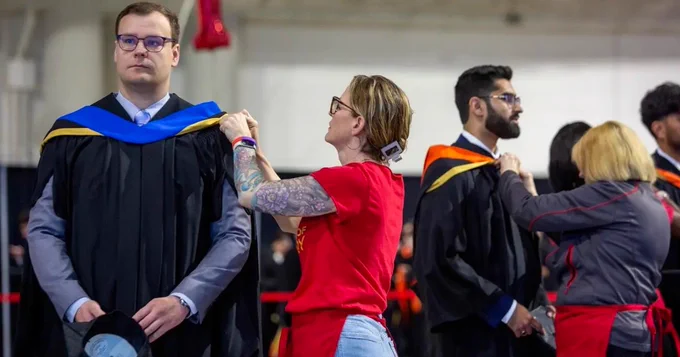 Grads getting ready for their convocation ceremony.
