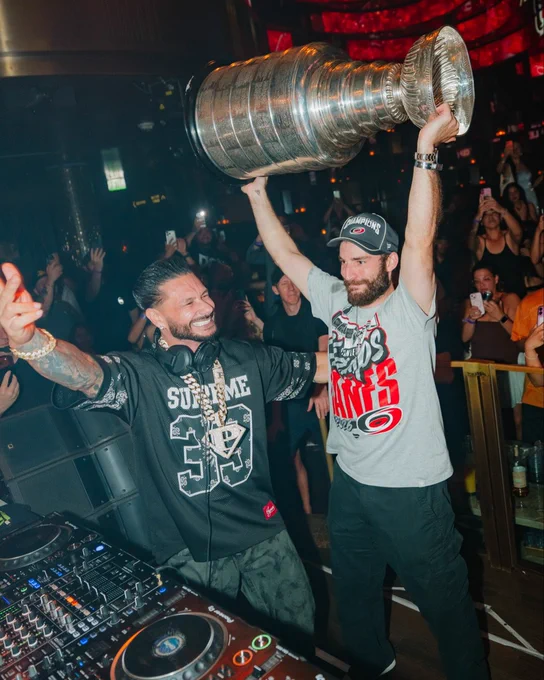 DJ Pauly D celebrates with Carolina Hurricanes players and the Stanley Cup. 