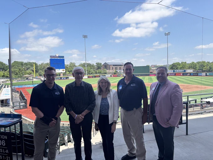 Gov. Evers poses for a group photo with staff at baseball stadium