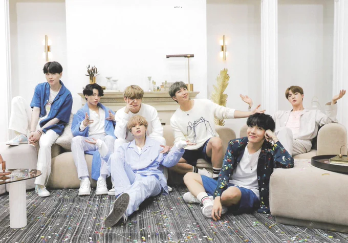 bts ot7 in 2020 recording a performance for the tonight show. they're dressed in cozy pajamas in a living room set. jungkook has a cute perm and vmin are being domestic as hell.