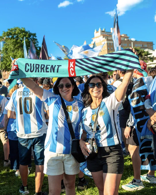 Argentina fans holding up a teal KC Current scarf