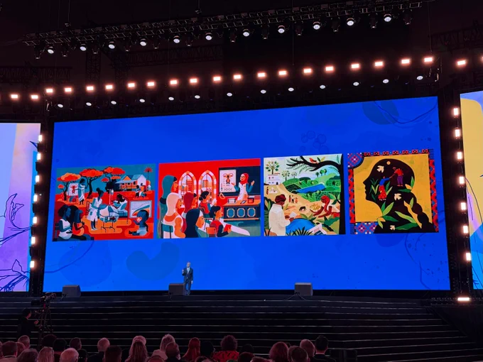 Rotary Foundation Chair Holger Knaack speaks on the main stage during a Rotary International Convention general session in Taipei. Behind him, a large screen displays colorful illustrations representing Rotary-supported community health, education, environmental, and development initiatives as attendees watch from the audience.