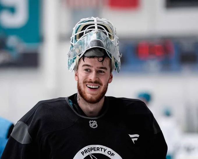 Yaroslav Askarov smiling during practice in a black jersey with his helmet on top of his head