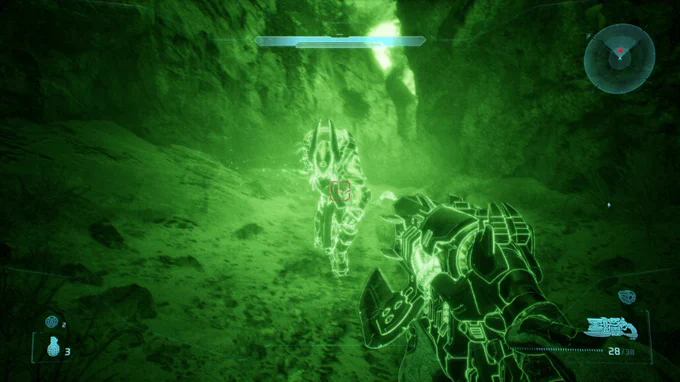 A Covenant Elite illuminated in nightvision green hues, aiming a weapon  in a dark, rocky environment. The atmosphere conveys a sense of tension and action.