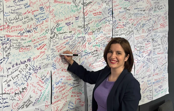 Bridget Phillipson signing the campaign wall in Makerfield.