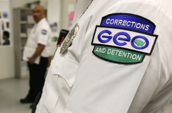 GEO Group logo badge on officer's shirtsleeve