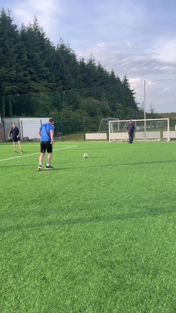 Photo of 3 men playing soccer on an outdoor pitch
