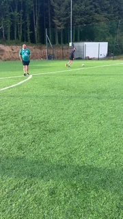 Photo of 2 men playing soccer on an outdoor pitch