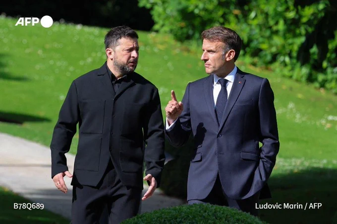 France's President Emmanuel Macron (right) greets his Ukrainian counterpart Volodymyr Zelensky ahead of the working session during the G7 summit in Evian, eastern France, on June 16, 2026.
