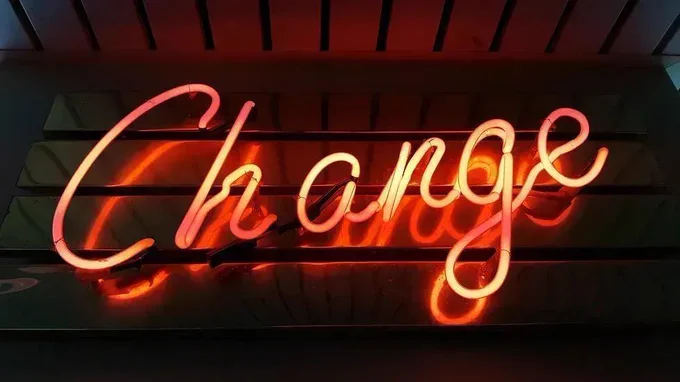 Florescent red and yellow signage spelling out the word change.