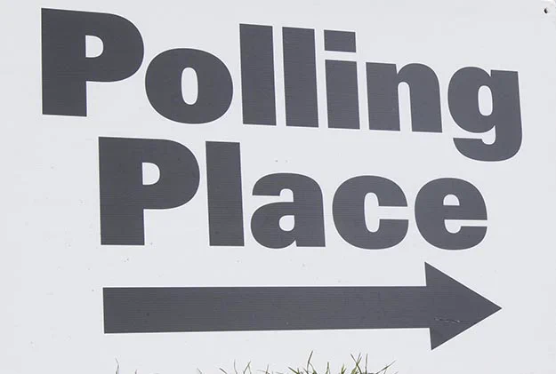 Sign indicating "Polling Place" with an arrow pointing to the right.