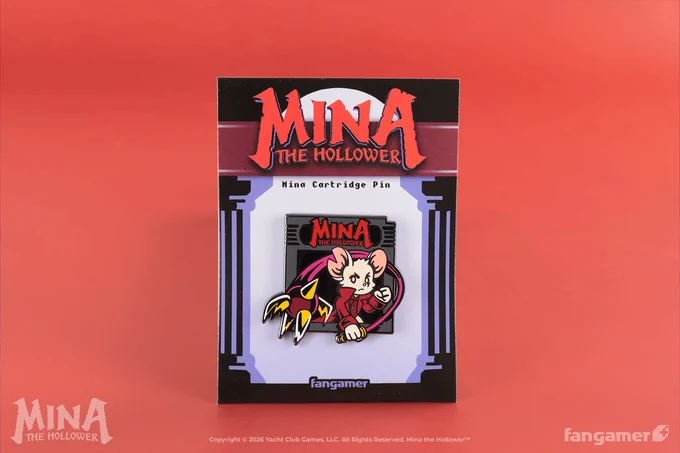 A photo of the Mina Cartridge pin, a Mina the Hollower enamel pin designed to look like Mina, wielding the Nightstar, is popping out of the label space of a game cartridge. The pin is photographed here in its Mina-themed packaging. 