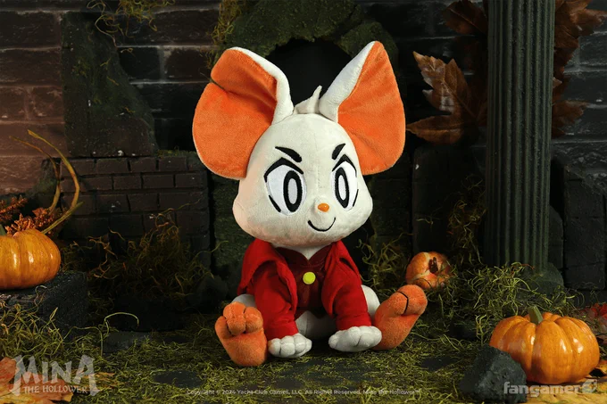 A photo of the Mina the Hollower plush in a studio set designed to look like the outside of a castle at night. 