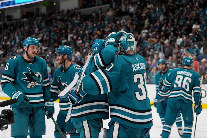 Barclay Goodrow hugging Yaroslav Askarov on the ice in the Sharks' teal jersey