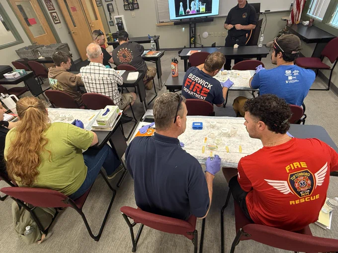 Tuftonboro HazMat Ops class analyzes samples of chemicals in a classroom setting.