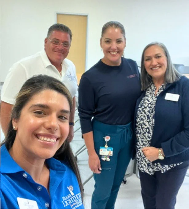 (Photo) A group selfie of four people: three Miami Lighthouse team members and a therapist from Nicklaus Children's Hospital, all smiling for the camera.

Miami Lighthouse Team:
  • Raquel Van Der Biest, Registered and Licensed Occupational Therapist and Certified Low Vision Therapist
  • Rachel Echevarría, Certified Occupational Therapy Assistant
  • John Garcia, Licensed Dispensing Optician