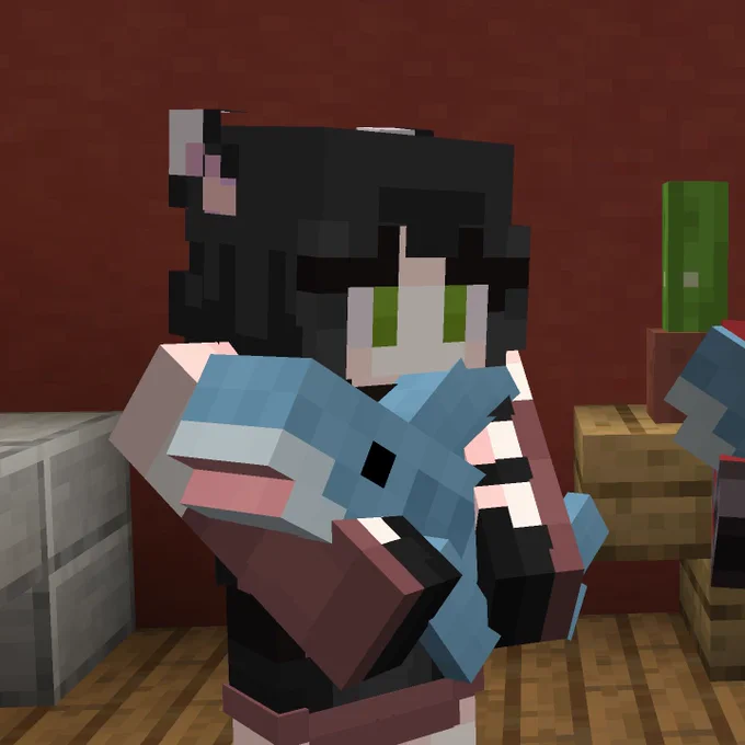 A Minecraft player holds a Blahaj plush shark.