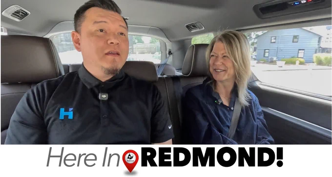 Mayor Birney and guest riding on RedLink through Redmond.