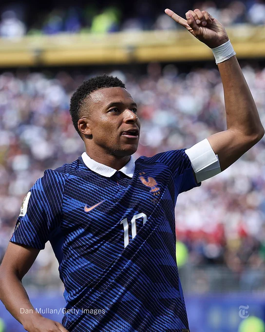 Kylian Mbappé celebrates holding up his hand with a no.1 gesture