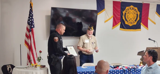 Sgt. Blake O'Dell accepts the OSUPD Officer of the Year award from the Stillwater American Legion Post 129. 