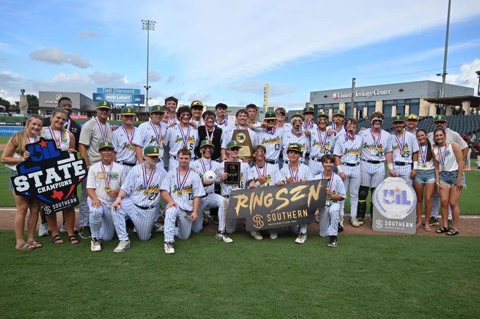 Boyd baseball team poses with gold trophy and state championship signs. 
