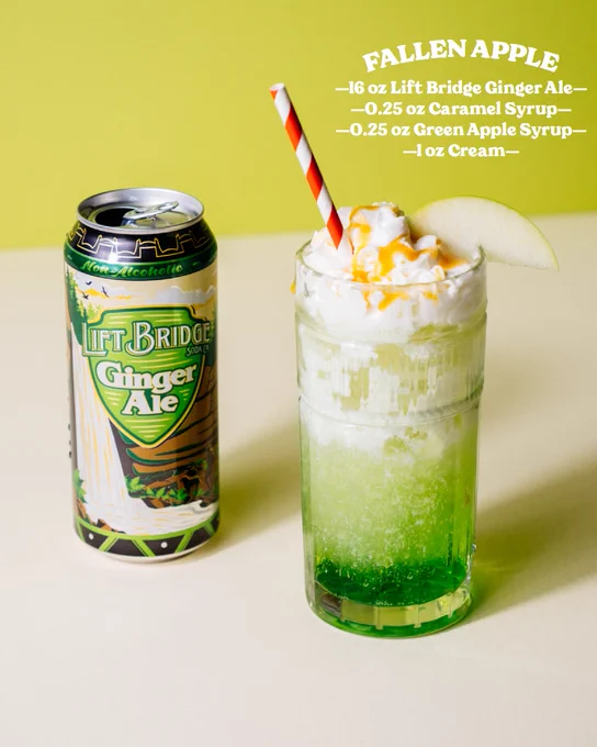 A vibrant green Fallen Apple drink made with Lift Bridge Ginger Ale, topped with whipped cream and caramel drizzle, served next to a can of ginger ale.