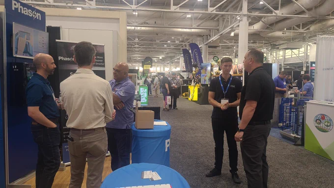 Visitors and industry partners gather at the Phason Controls booth during World Pork Expo 2026. Team members engage in conversations about AutoFlex Connect, and Smart Barn Analytics.