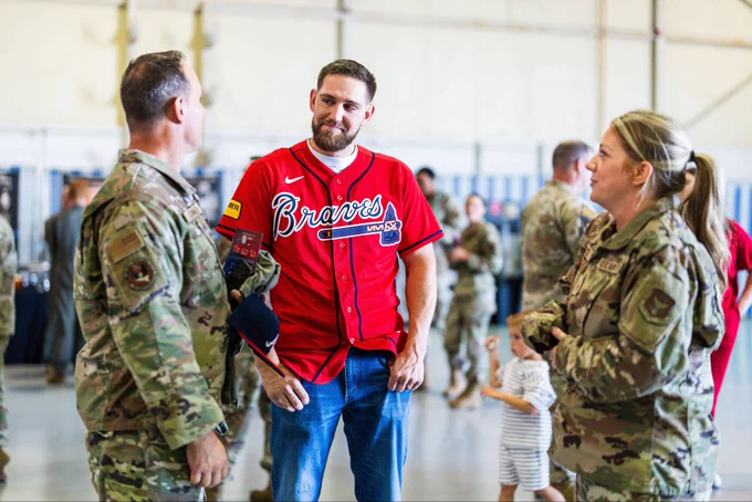 Dylan Lee speaks with two military members