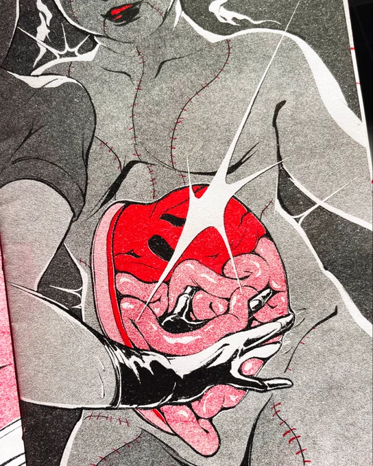 Risograph print in black and red of a character with their abdomen open, showing their organs. From the side, another character’s gloved hand reaches into them.