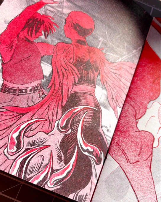 Risograph print in black and red. To the left, two characters dance. One has bird claws for feet. To the right, skeletons dance.