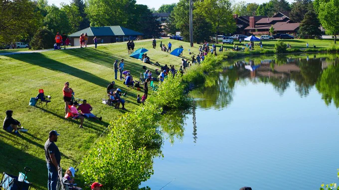 All ages surround the lake at Sanborn Park for the annual fishing derby.