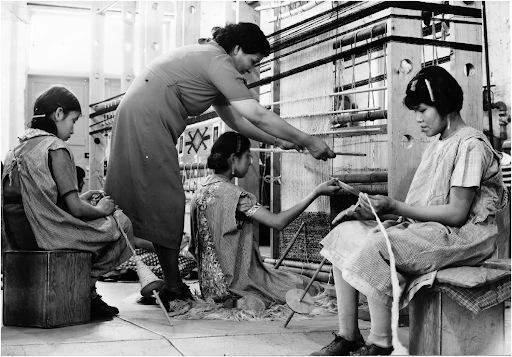 Navajo girls weaving with their Diné teacher, Marie Martin, Leupp Indian School 1941 (NF2-12, Milton Snow Collection, Courtesy of Navajo Nation Museum). Two Bears, D. R. (2021).
