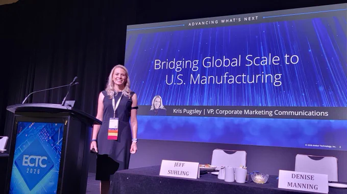 Kris Pugsley stands next to a presentation screen displaying the title 'Bridging Global Scale to U.S. Manufacturing' at the ECTC 2026 conference. The screen also shows the name Kris Pugsley with the title VP, Corporate Marketing Communications. In front, there are two name cards on a table reading 'Jeff Suhling' and 'Denise Manning.' The setting is a conference room with a podium and chairs.